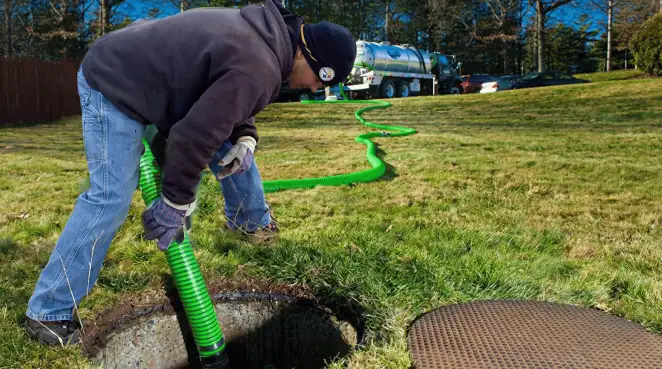 Service technician performing residential septic pumping and drainage maintenance in Allentown, PA